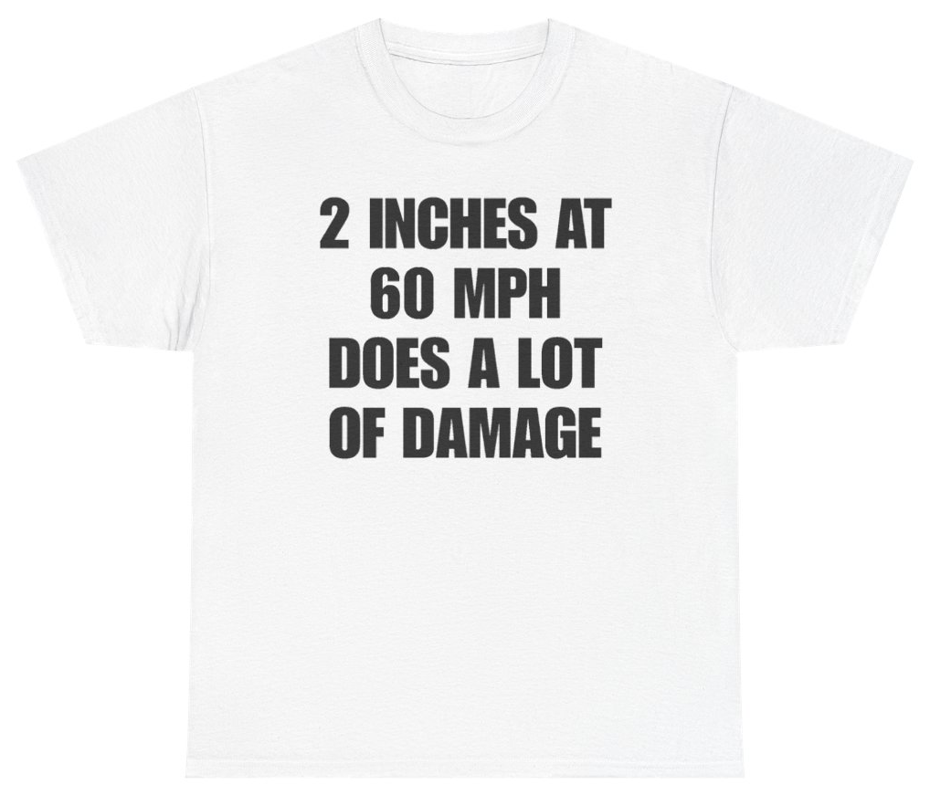 Funny 2 Inches At 60 MPH Does A Lot Of Damage Tee T-Shirt featuring bold sarcastic humor and graphic design, perfect for casual wear and humor lovers