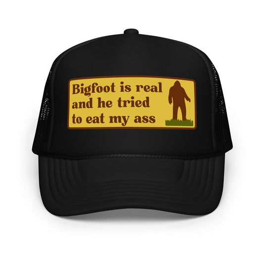 Funny inappropriate trucker hat with bold text that says “Bigfoot Is Real And He Tried To Eat My Ass” — a hilarious mesh-back hat for men who love crazy hats, weird humor, and legendary funny hat sayings perfect for parties or festivals.