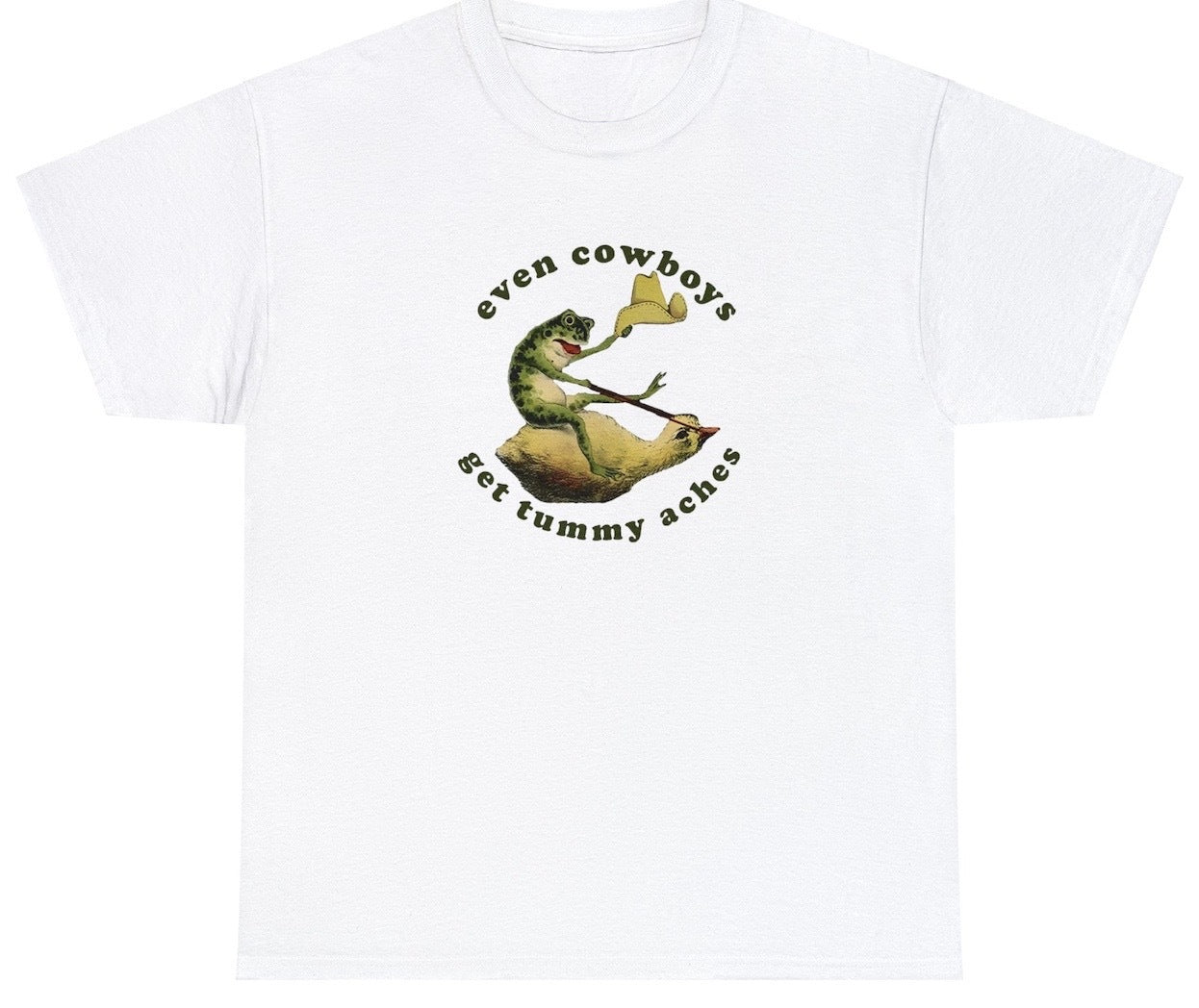 "Lighthearted 'Even Cowboys Get Tummy Aches' t-shirt, perfect for fans of quirky Western humor and playful designs. Ideal for casual wear and funny gifts."