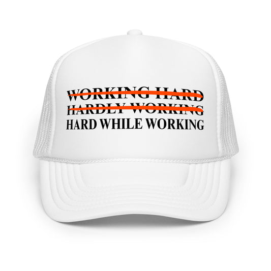 Inappropriate funny mesh trucker hat with bold black text that says “Working Hard Hardly Working Hard While Working” — a hilarious hat for men who love innuendos, dirty humor, and wearing something outrageous to work or parties.