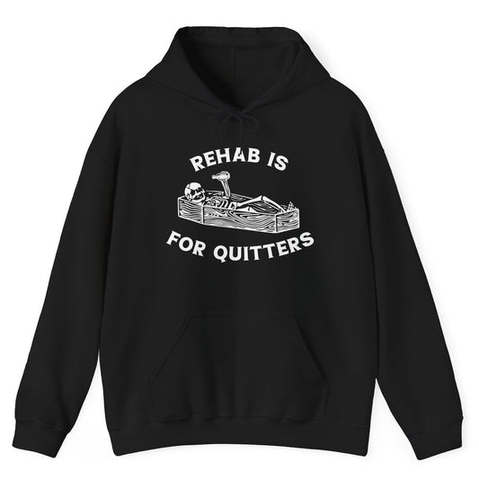 Funny "Rehab Is For Quitters" hoodie featuring a skeleton in a coffin drinking, paired with bold and dark humor. Perfect for casual wear and gag gifts.